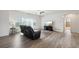 Bright and airy living room featuring wood flooring and modern decor at 56432 E 23Rd Ave, Strasburg, CO 80136