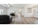Inviting living room with modern décor, wood floors, and archway leading to the bathroom at 56432 E 23Rd Ave, Strasburg, CO 80136