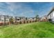 Expansive backyard featuring a well-maintained lawn, a wood fence, and neighboring homes at 1465 Gentle Rain Dr, Castle Rock, CO 80109