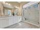 Modern bathroom featuring double sinks, stylish lighting, and a luxurious walk-in shower with a built-in seat at 1465 Gentle Rain Dr, Castle Rock, CO 80109