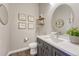 Stylish bathroom with a modern vanity, oval mirror, and decorative wall art at 1465 Gentle Rain Dr, Castle Rock, CO 80109
