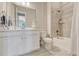 Clean bathroom with white vanity, large mirror, and combined bathtub and shower with tiled surround at 1465 Gentle Rain Dr, Castle Rock, CO 80109