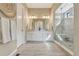 Bright bathroom with double vanity, large mirrors, and walk-in shower with glass enclosure at 1465 Gentle Rain Dr, Castle Rock, CO 80109