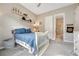 Bright bedroom featuring decorative shelves and an ensuite bathroom at 1465 Gentle Rain Dr, Castle Rock, CO 80109