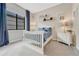 Neutral bedroom with dark curtains, white furniture, and decorative shelving at 1465 Gentle Rain Dr, Castle Rock, CO 80109