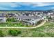 Expansive neighborhood view highlighting charming homes, lush green spaces, and walking trails at 1465 Gentle Rain Dr, Castle Rock, CO 80109