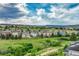 Scenic view of a neighborhood with colorful homes, green spaces, and a beautiful cloudy sky at 1465 Gentle Rain Dr, Castle Rock, CO 80109