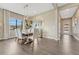 Elegant dining room with hardwood floors, large window, modern light fixture and room for six at 1465 Gentle Rain Dr, Castle Rock, CO 80109