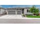 Charming home featuring a three-car garage, modern exterior, and manicured lawn at 1465 Gentle Rain Dr, Castle Rock, CO 80109