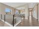 Open hallway featuring hardwood floors and a railing overlooking the dining room at 1465 Gentle Rain Dr, Castle Rock, CO 80109