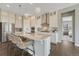 Modern kitchen with stainless steel appliances, a large island with seating, and stylish pendant lighting at 1465 Gentle Rain Dr, Castle Rock, CO 80109
