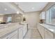 Bright kitchen area with white cabinetry, granite countertops, pendant lighting, and modern appliances at 1465 Gentle Rain Dr, Castle Rock, CO 80109