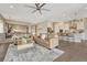Open-concept living room featuring hardwood floors, comfortable seating, and kitchen access at 1465 Gentle Rain Dr, Castle Rock, CO 80109