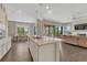 Open concept living space features a kitchen island, dining area, and comfortable seating with lots of natural light at 1465 Gentle Rain Dr, Castle Rock, CO 80109