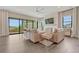 Bright living room featuring hardwood floors, fireplace, large windows and comfortable seating at 1465 Gentle Rain Dr, Castle Rock, CO 80109