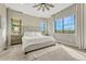 Spacious main bedroom with plush carpet, large windows offering city views, and a decorative ceiling fan at 1465 Gentle Rain Dr, Castle Rock, CO 80109
