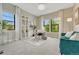 Bright and spacious home office features large windows, built-in shelving, and a comfortable seating area at 1465 Gentle Rain Dr, Castle Rock, CO 80109