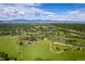 Panoramic aerial view of lush green landscape and park with a lake and walking trails at 6982 Estes Dr, Arvada, CO 80004