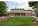 Beautiful backyard with a well-maintained lawn, patio area, and a wooden fence for privacy at 6982 Estes Dr, Arvada, CO 80004