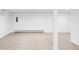Spacious basement showcasing sleek flooring, white column, and potential for customization at 6982 Estes Dr, Arvada, CO 80004