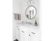 Well-lit bathroom with a modern vanity, decorative mirror, and stylish fixtures at 6982 Estes Dr, Arvada, CO 80004