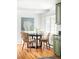 Cozy dining area with woven chairs and a modern black table, adjacent to kitchen at 6982 Estes Dr, Arvada, CO 80004