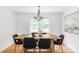 Formal dining room featuring a wooden table, black chairs, and a modern chandelier at 6982 Estes Dr, Arvada, CO 80004