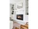 Bright living room with cozy fireplace, built-in shelving and warm color scheme at 6982 Estes Dr, Arvada, CO 80004