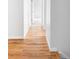 Hallway with hardwood floors leads to bright rooms providing a seamless transition throughout the home at 6982 Estes Dr, Arvada, CO 80004