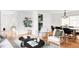 Bright living room with hardwood floors, stylish furniture, and a view into the modern kitchen at 6982 Estes Dr, Arvada, CO 80004