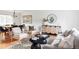 Open-concept living space with modern furnishings, a dining area, and natural light at 6982 Estes Dr, Arvada, CO 80004