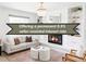 Cozy living room features fireplace, built-in shelves, and stylish decor at 6982 Estes Dr, Arvada, CO 80004