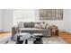 Comfortable living area with a plush sofa, contemporary decor, and a bright window at 6982 Estes Dr, Arvada, CO 80004