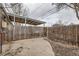 Enclosed backyard with a wooden fence and a covered patio area at 1533 Xenia St, Denver, CO 80220