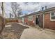Brick home's backyard features a wood fence, patio, and convenient access into the house at 1533 Xenia St, Denver, CO 80220