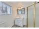 Bathroom featuring a white vanity, modern mirror, and a glass enclosed shower at 1533 Xenia St, Denver, CO 80220