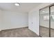 Spacious bedroom with mirrored closet doors, white walls, and a large window at 1533 Xenia St, Denver, CO 80220