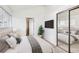 Bright bedroom featuring mirrored closet, ensuite bath and serene decor at 1533 Xenia St, Denver, CO 80220