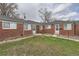 Brick exterior of a multi-Gathering home with well-maintained landscaping in a residential neighborhood at 1533 Xenia St, Denver, CO 80220
