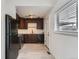 Modern kitchen with dark wood cabinets, stainless steel appliances, and light wood floors at 1533 Xenia St, Denver, CO 80220