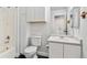 Bathroom with a shower/tub combination, toilet, and single sink vanity with all white cabinets at 9508 Elk Mountain Cir, Littleton, CO 80125