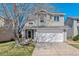 Charming two-story home with a well-manicured lawn, mature tree and a two car garage at 9508 Elk Mountain Cir, Littleton, CO 80125