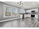 Kitchen featuring stainless steel appliances, white cabinets, dark countertops, and two large windows for natural light at 9508 Elk Mountain Cir, Littleton, CO 80125