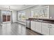 Bright kitchen with stainless appliances, white cabinetry, a window, and sliding glass doors to the outside deck at 9508 Elk Mountain Cir, Littleton, CO 80125