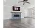 Open-concept living room boasts a modern fireplace, new floors and lots of natural light at 9508 Elk Mountain Cir, Littleton, CO 80125