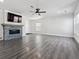 Spacious living room with fireplace, ceiling fan and gray wood-look flooring at 9508 Elk Mountain Cir, Littleton, CO 80125