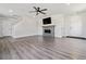 Spacious living room featuring a modern fireplace, new floors and ceiling fan at 9508 Elk Mountain Cir, Littleton, CO 80125