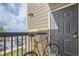 View of a cozy outdoor balcony featuring a bike, and a secure entryway to the home at 1465 Blue Sky Cir # 17-203, Erie, CO 80516