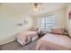 Bright bedroom with two twin beds and a large window at 1465 Blue Sky Cir # 17-203, Erie, CO 80516