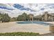 A large swimming pool with pristine blue water and an inviting deck, with lush landscaping surrounding the facility at 1465 Blue Sky Cir # 17-203, Erie, CO 80516